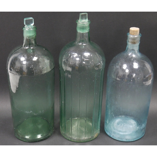 80 - Three large green-blue glass bottles and stoppers, one named for POISON, one cork stopper a replacem... 