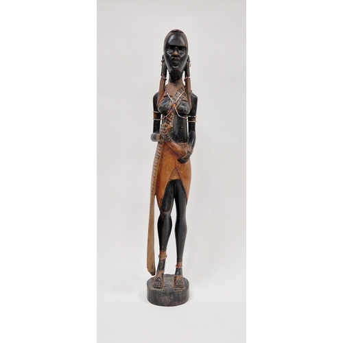 152 - Carved wooden figure of an African girl with beaded decoration to her ankles and chest, 62cm high