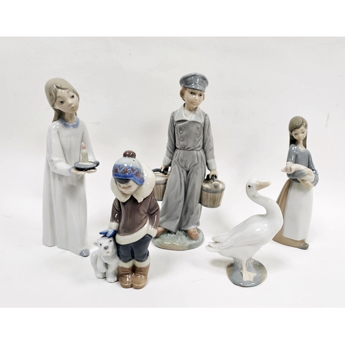 33 - Collection of Lladro figures comprising a girl with candlestick, a boy holding two pails, a boy besi... 