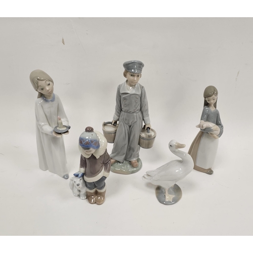 33 - Collection of Lladro figures comprising a girl with candlestick, a boy holding two pails, a boy besi... 