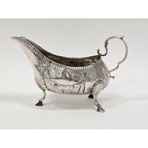 441 - George III Irish silver sauceboat by Matthew West, Dublin (no date letter), decorated with garlands,... 