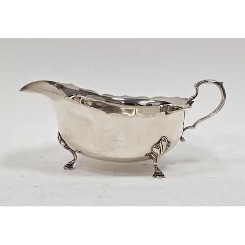 460 - Georgian-style silver sauceboat of typical oval form with everted ogee cut-card borders and raised o... 