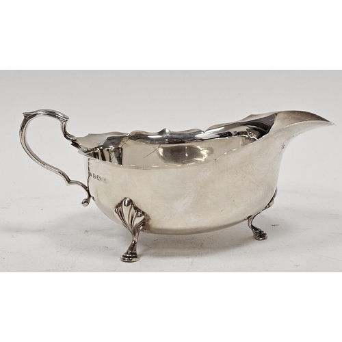 460 - Georgian-style silver sauceboat of typical oval form with everted ogee cut-card borders and raised o... 