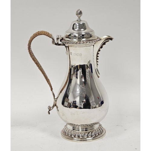 462 - Late Victorian crested silver hot water jug, baluster-shaped and having high domed lid and spirally ... 