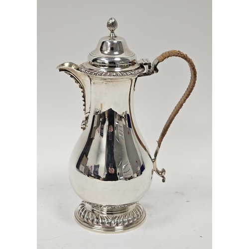 462 - Late Victorian crested silver hot water jug, baluster-shaped and having high domed lid and spirally ... 