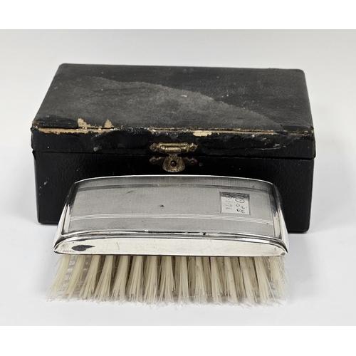 485 - Elizabeth II silver backed engine turned clothes brush, in leather box, engraved with initials and t... 