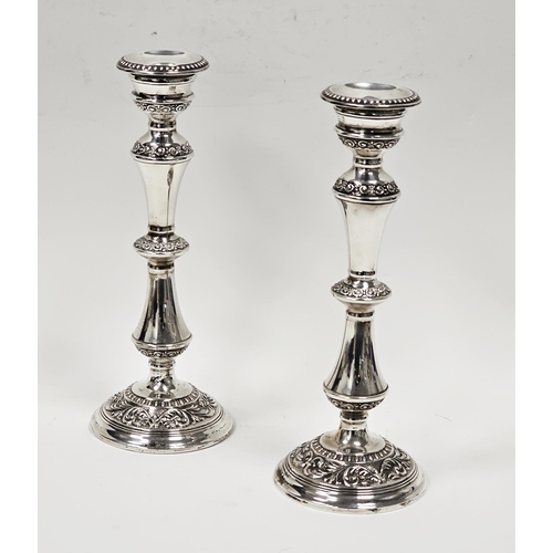 530 - Pair of Elizabeth II silver candlesticks embossed scrolling and acanthus motifs, Birmingham 1966 by ... 