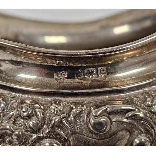 556 - Pair of Edwardian silver salts, Birmingham 1904, of shaped oval design with floral and scroll decora... 