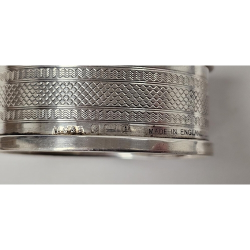 575 - Three various silver napkin rings, silver photograph frame, rectangular with scroll and foliate bord... 