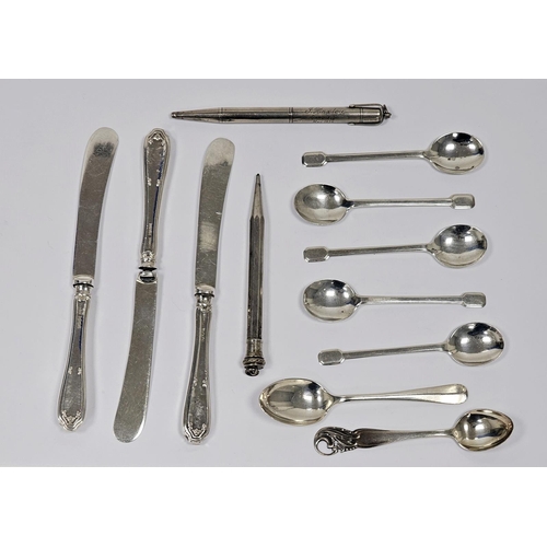 581 - Two various silver-coloured metal propelling pencils, five silver coffee spoons with spade handles a... 