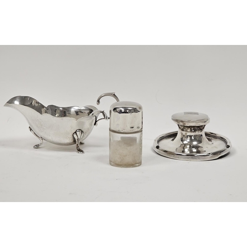 588 - An Edwardian silver cream jug, of plain form, scalloped edge, raised on three pad feet, scroll handl... 