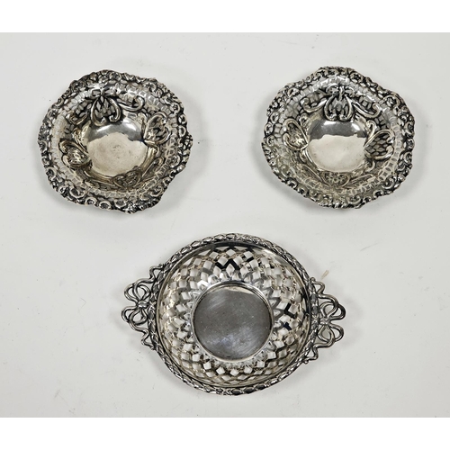 591 - A pair of Victorian silver pierced circular bonbon dishes, embossed with heart motifs, raised on thr... 