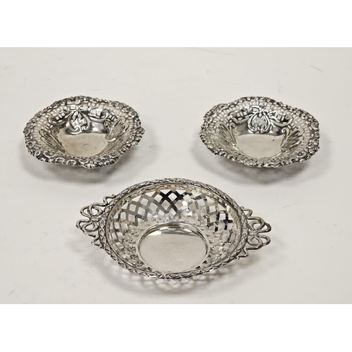 591 - A pair of Victorian silver pierced circular bonbon dishes, embossed with heart motifs, raised on thr... 