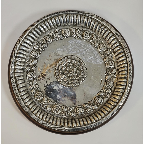 637 - Indian white metal dish of circular form with floral decoration within a gadrooned border, 20cm diam... 