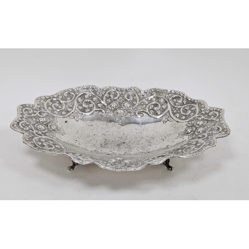 652 - White metal shaped oval bowl with floral and scrolling decoration, on four bracket feet, marked 925,... 