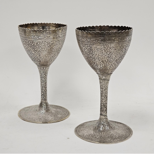 655 - Pair Indian silver coloured metal goblets, with scalloped rim allover chased with flowerhead and scr... 