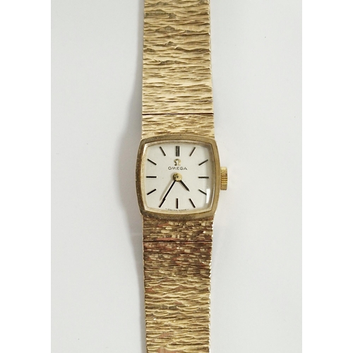 679 - Vintage lady's 9ct gold Omega wristwatch, the square silvered dial with raised black baton hour mark... 