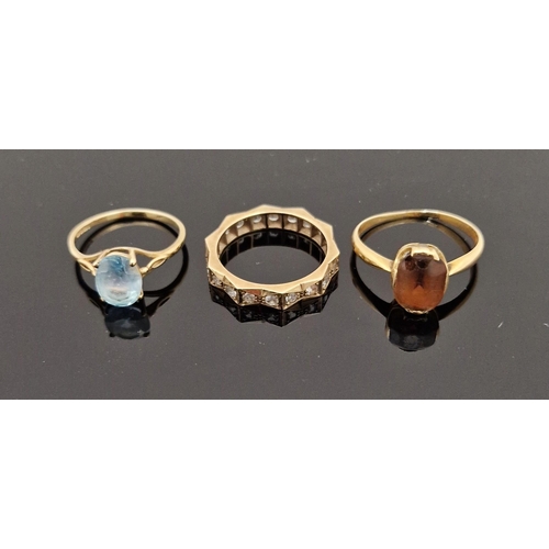 755 - 9ct gold and blue stone set ring and a 9ct gold, a white stone set eternity ring and a gold-coloured... 