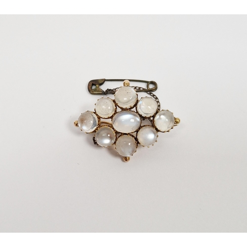 769 - Gold-coloured metal and moonstone brooch, lozenge-shaped, having central oval stone surrounded by ei... 