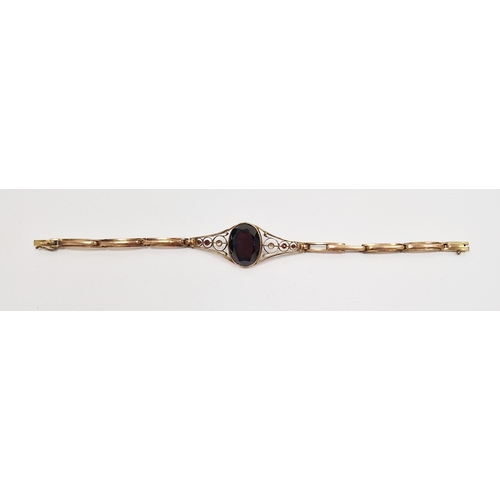 817 - LOT WITHDRAWN
 9ct gold and garnet bracelet set oval cut stone with scroll shoulders, having small s... 