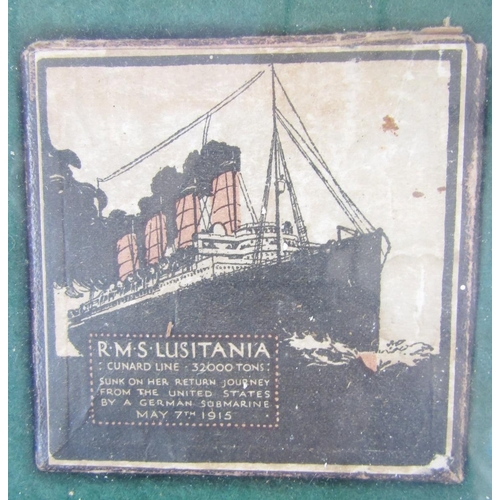 239 - Two WWI RMS Lusitania medals with box and leaflet within glazed frame.