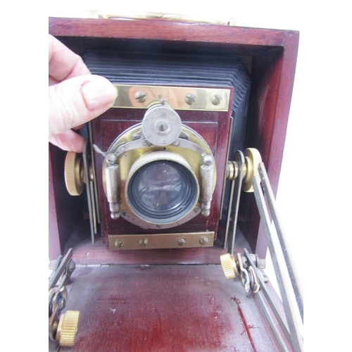 263 - Early 20th Unicum bellow field camera, mahogany and brass bound case, marked Bausch and Lomb co