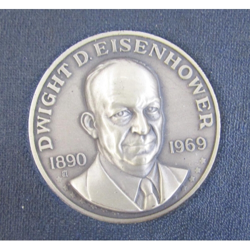 318 - Eisenhower commemorative set made up of silver medallion and 6c postage stamp, and US numismatic int... 