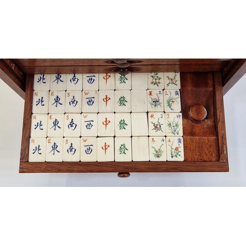 400 - Bone and wood mahjong set with instruction booklet, in stained wood five-drawer table top cabinet wi... 