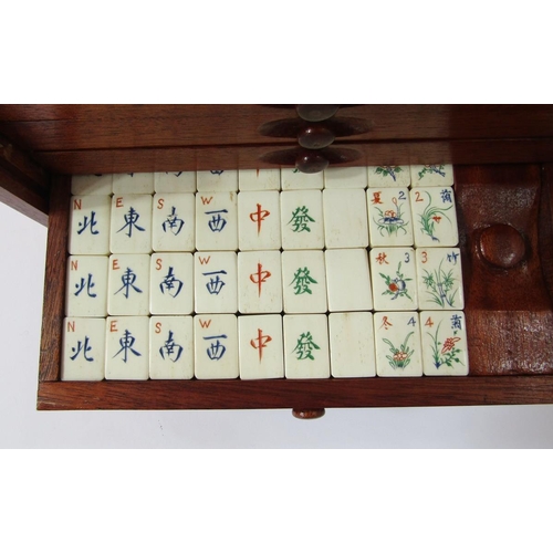 400 - Bone and wood mahjong set with instruction booklet, in stained wood five-drawer table top cabinet wi... 