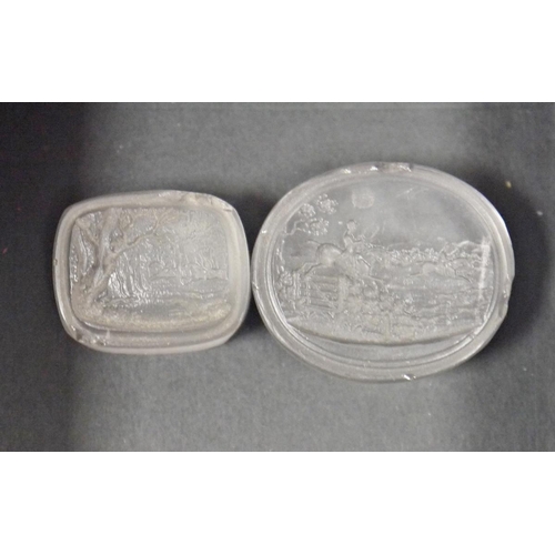 192 - Two 19th century rock crystal seals, both with carved with hunting scenes, one oval 3.4cm long and t... 