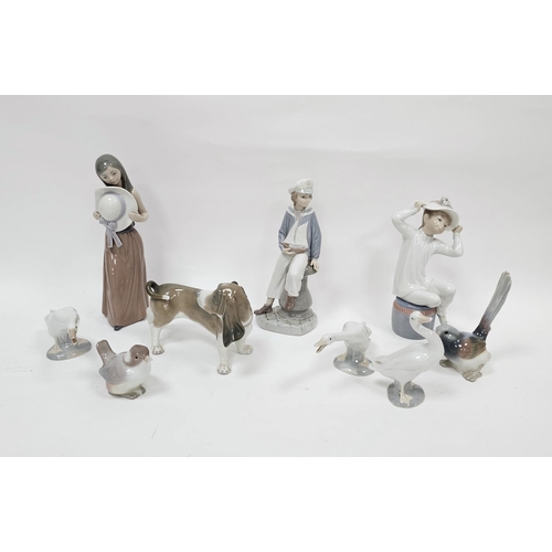 76 - Collection of nine Lladro figures and animals including Bassett hound, boy holding pond yacht, girl ... 