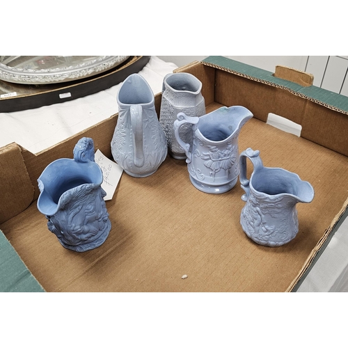 79a - Collection of approximately twenty two 19th century moulded relief jugs with a pale blue glaze