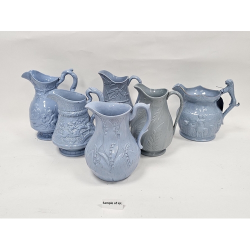 79b - Collection of approximately twenty two 19th century stoneware moulded relief jugs with pale blue gla... 