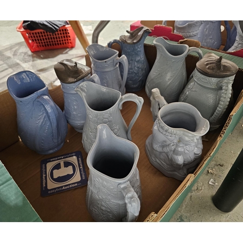 79b - Collection of approximately twenty two 19th century stoneware moulded relief jugs with pale blue gla... 