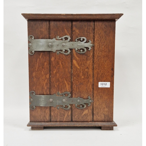 1010 - Late 19th/early 20th century oak table-top/hanging cabinet, the single hinged door mounted with faux... 