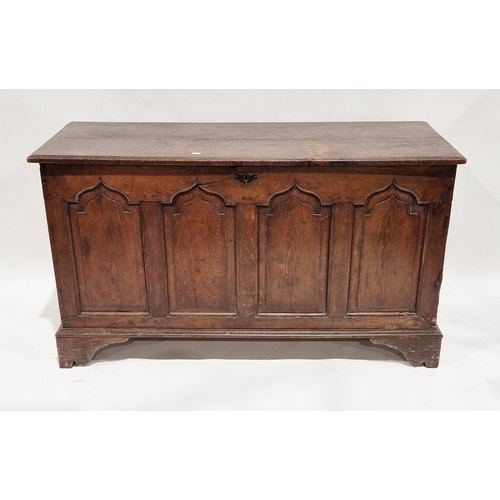 1026 - 18th / 19th century oak coffer, the hinged lid opening to an empty space, four arched moulded panels... 