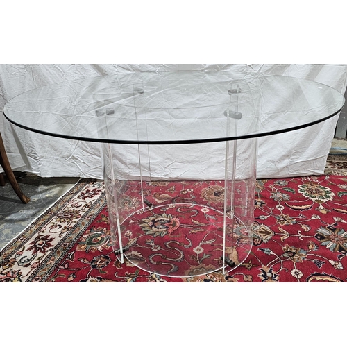 1029 - Contemporary circular dining table, the circular clear glass top supported on two joined clear lucit... 