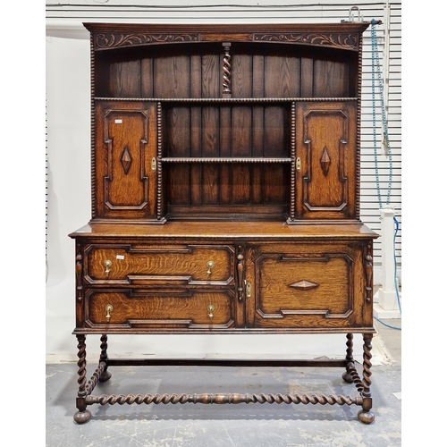 1034 - Oak dresser in the 17th century Jacobean-style, the upper section with two open plateracks and two c... 