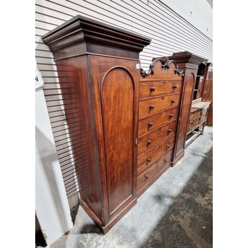 1035 - Early 19th century mahogany century box compactum wardrobe, the central section of six long drawers ... 