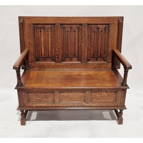 1093 - Early 20th century Waring & Gillows oak monk's bench, the three-panel top folding back to form a ben... 