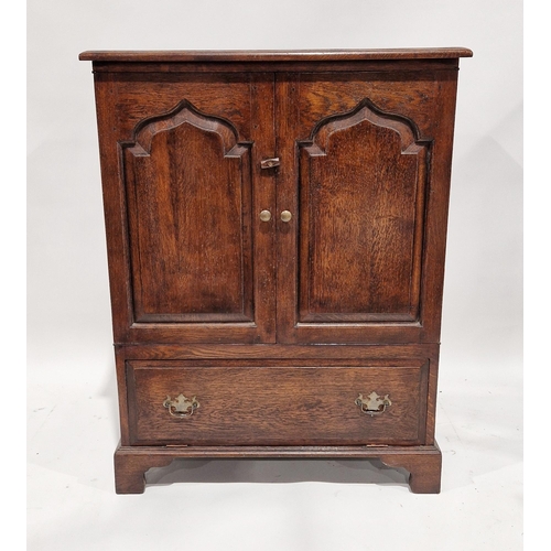 1099 - Oak television/media cabinet in the form of a 17th century cupboard, with two carved panel doors abo... 