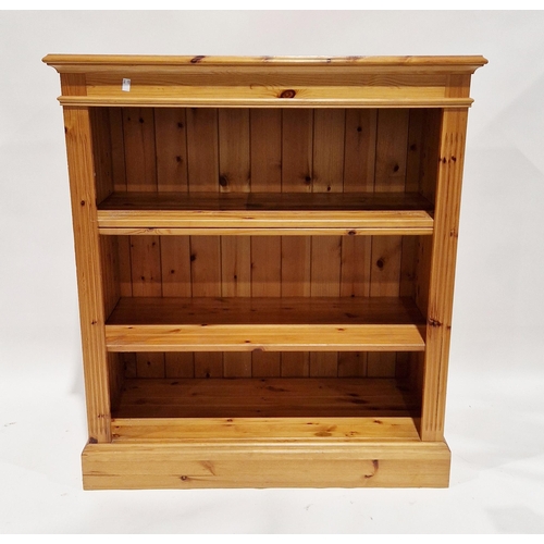 1101 - 20th century pine bookcase with three adjustable shelves, raised on a plinth base, 97cm wide x 107cm... 