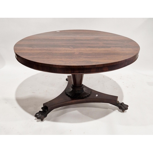 1157 - A William lV/early Victorian rosewood breakfast table, the circular tilt top raised on a tapered sup... 