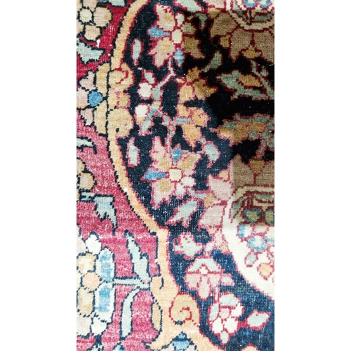 1212 - Eastern wool rug of Persian design, having black arabesque to the cherry red field with allover flor... 