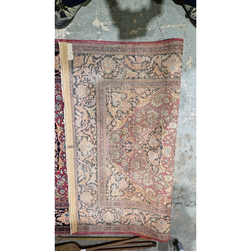 1212 - Eastern wool rug of Persian design, having black arabesque to the cherry red field with allover flor... 