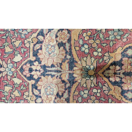 1212 - Eastern wool rug of Persian design, having black arabesque to the cherry red field with allover flor... 