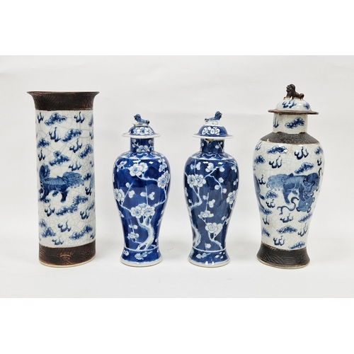 128 - Pair Chinese porcelain inverse baluster vases with prunus decoration on a blue wash ground, with cov... 