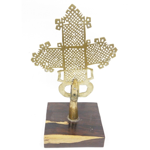 174 - Ethiopian brass coptic Cross, mounted on a lignum vitae square base, 48cm high