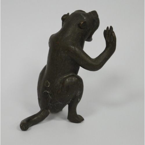 188 - Early 20th century bronze model of a monkey, seated and holding its arms as if in support, jaw open ... 