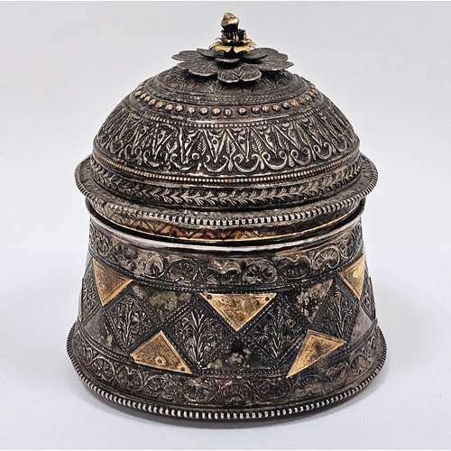 333 - Indian white metal caddy or box, of cylindrical form with profuse intricate repousse decoration, the... 